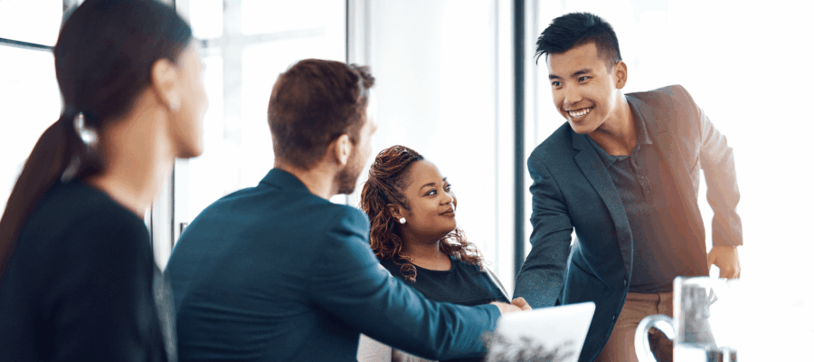 a group of employees where a man is shaking hands with another man